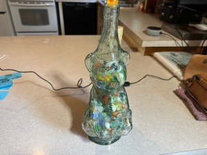 lot 202 image: Vintage Beverages Bear Bottle Green Circus Bear Playing Drum filled with Marbles
