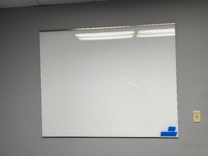 (1) Wall-mounted white board. Approx measurements 60 W x 49 H