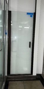 Frameless Pivot Shower Door wclear polished-edge glass panel, handle wmagnetic latch, horizontal drip trough. 29 W X 71 H