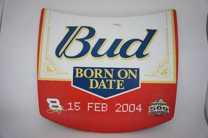 lot 15 image: Large Tin Replica Hood Budweiser Bud BORN ON DATE 2004 Daytona 500 Champion Mini Tribute Tin Hood with Original Plastic Peel-Off Coating Still Intact...