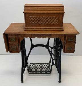 lot 268 image: 1891-1893 Singer Coffintop Sewing Machine Style 9  I.F. Or V.S. No. 2 Number 1164859 With Sphinx Design On Platform With Original Manual & More