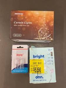 lot 38 image: Lot of Lighting Items Jmexsuss Curtain Lights, Anyray Halogen Light Bulbs, onn. LED Fairy Light String