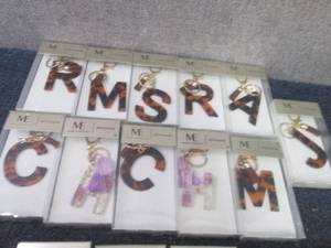 lot 124 image: 11 Monogram Keychains...
