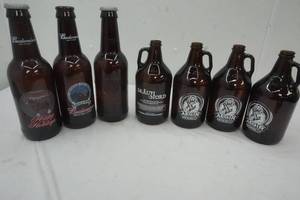 lot 46 image: Four Mickey Finns Brewery Growlers and Three Glass Budweiser Bottles with caps 15 tall