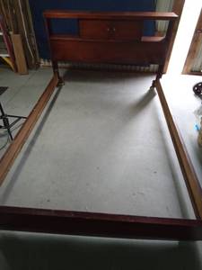 lot 1 image: Solid wood vintage bed frame on wheels