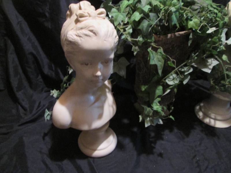 Eye for Elegance with faux foliage amid ceramic bust decor
