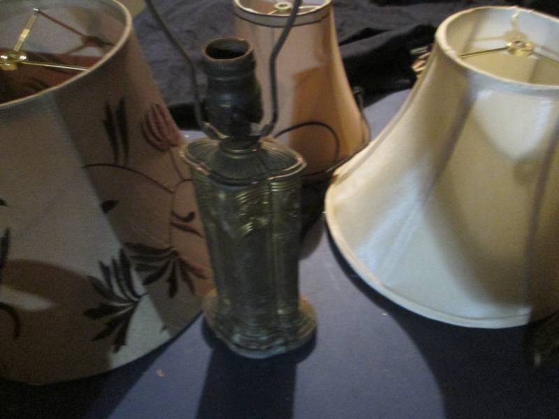 Brass tone Lamp and wall decor with a small selection of lamp shades