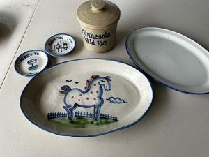 lot 115 image: MA Hadley Horse 14 Oval Platter Serving Tray, Two Small Spoon RestsCoasters, Blue Rimmed Platter, and Minnesota Wild Rice Canister