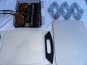 lot 187 image: Two Solid Cutting Boards, New Grill Basket, and Expandable Trivet