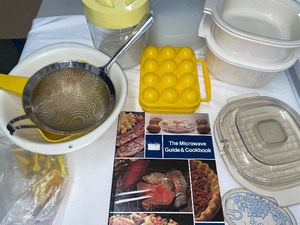 lot 138 image: Variety of Microwave Dishes, Cookbook, Strainers, and Egg Storage Box