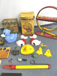 lot 13 image: Vintage Toy Lot - Disneys Donald Duck The Gay Cabellero9 Trophy Slide WhistleWolverine Supply & Mfg Co Shoot-A-Loop Tin Game1950s Fisher Price Kitty Bell Toy (Works)1942 Softball-Volleyball Guide with Rules and More