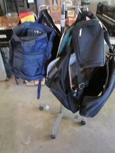 Rolling rack with assorted backpack...