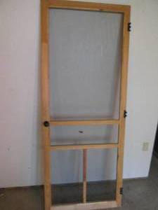 Pine frame screen door with handle.