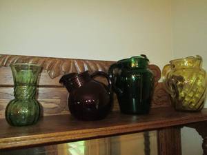 Colored glass water pitchers and va...