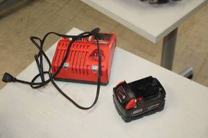 lot 12 image: Milwaukee M12M18 Battery Charger with (1) Milwaukee M18 Red Lithium XC5.0 18V Battery