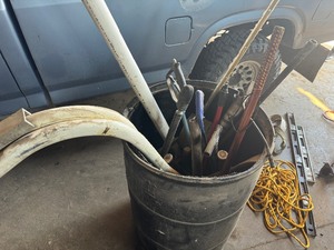 Barrel of Misc Items Walking Sticks, Baseball Bats, PVC Pipe, Pressure Washer Hose and more