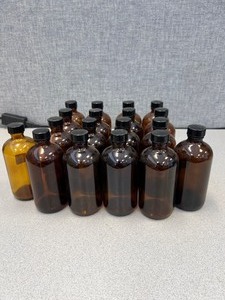 lot 110 image: 18 - Amber Glass Bottles With Screw Caps, 5 Inches Tall, 2.5 Inches Wide