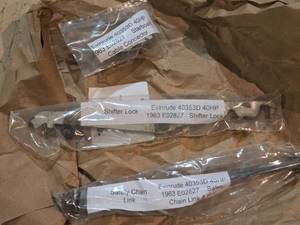 lot 233 image: Evinrude 40353D 40 HP Vintage Boat Motor Parts Starboard Cable Connector, Shifter Lock and Chain Link and Bolt