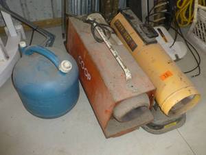 Two garage heaters with a jug of kerosene