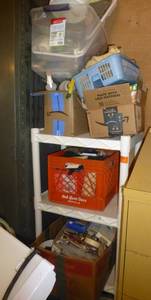 White shelving full of painting, gardening, car wash supplies