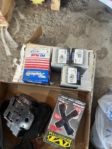 pile of car parts  muffler  brake parts  dodge hub caps