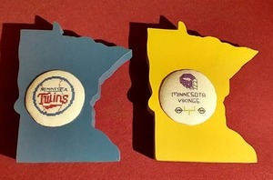 lot 54 image: (2) Minnesota Wood Plaques With TwinsVikings Cross Stitch Logos