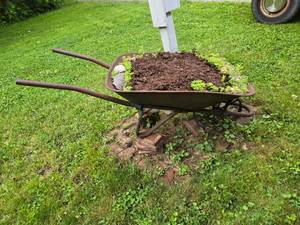 lot 94 image: Steel Wheel Wheelbarrow Yard Art Decor