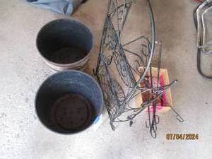 lot 37 image: Metal framed folding plant stand, outdoor planters, lava rocks and short flowerflag hangers