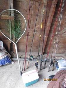 lot 48 image: Assortment of Daiwa fishing rods and reels with other brands with fishermans net plus Igloo travel cooler