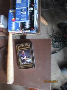 lot 51 image: Lot of sports related VHS tapes, wood baseball bat and Every day is game day book