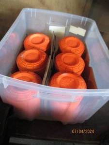 lot 53 image: Mid-size storage tote with fluorescent orange clay pigeons
