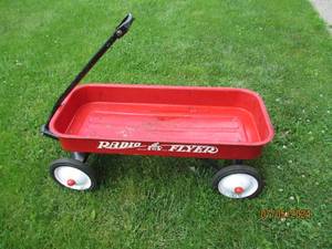 lot 64 image: Red metal Radio-Flyer wagon...