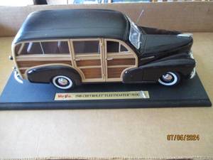 lot 13 image: Die cast model 1948 Chevrolet Woodgrain Fleetmaster replica car with moving parts