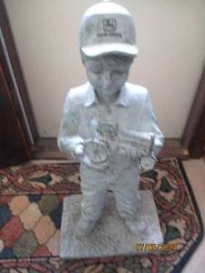 lot 4 image: Statue of a Little Boy wearing a John Deere hat while holding a John Deere tractor (approximately 3ft tall)