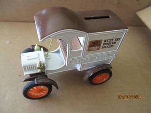 lot 75 image: Ertl Die cast replica bank with key of 1905 Fords First Delivery Car with Trust Worthy Hardware stores advertisement