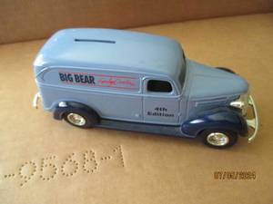 lot 79 image: Ertl Die cast replica bank with key of 4th Edition Big Bear Family Centers advertisement
