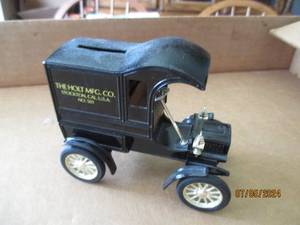 lot 87 image: Ertl Die cast replica bank with key of 1905 Fords First Delivery Car with The Holt Mfg Co Advertisement