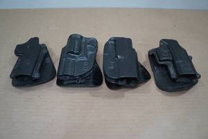 lot 70 image: 4 Formed Plastic Paddle Holsters