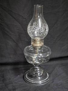 lot 21 image: Antique Clear Glass Oil Lamp with Decorative Chimney and Brass Burner