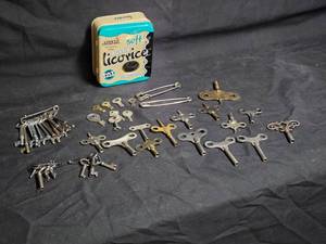 lot 49 image: Collection of Vintage Clock and Skeleton Keys with Licorice Tin