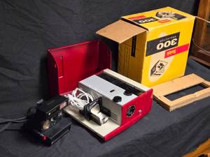 lot 64 image: Vintage Kodak 300 Projector and Polaroid 600 Camera Set