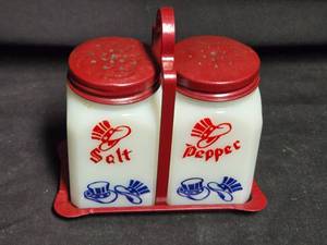 lot 298 image: Vintage Milk Glass Salt and Pepper Shakers with Red Metal Lids and Holder