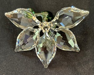 lot 258 image: Four Swarovski Crystal Society Figurines including Swarovski African Orchid Crystal Figurine