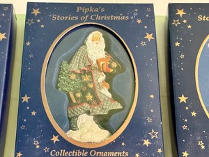 lot 180B image: Five Pipkas Stories of Christmas Santa Ornaments including Pipkas Stories of Christmas Ukrainian Santa Ornament