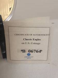 lot 27 image: COA American Mint - Classic Eagles - 24k Gold Layered Dollar Coin - B06764