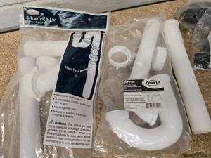 lot 39 image: Batch of plastic tubing, Moen single handle tubshower replacement cartridges and tank to bowl hardware sets