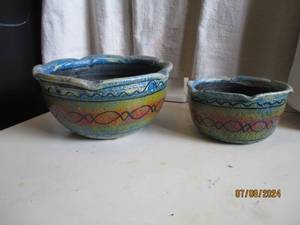 lot 49 image: Pair of Hand spun and painted clay ...