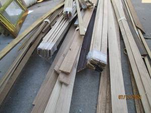 lot 689 image: Large lot of wood trim, some very long pieces