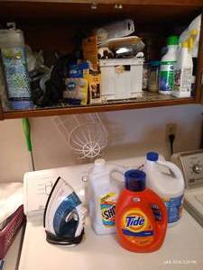 lot 197 image: Laundry Cabinet of Felt Pads, Iron, Cleaners, Laundry Mesh Bags