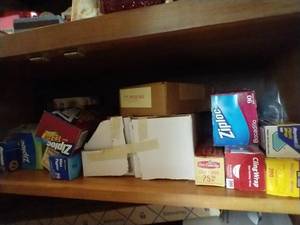 lot 261 image: Shelf of Plastic Wraps, Ziploc Bags, Wax Paper, Produce Bags, Etc